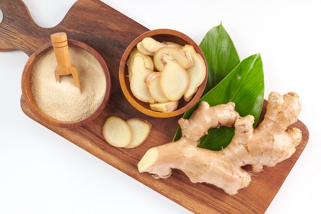 Ginger root and ginger powder in the bowl. Ginger tea and ingredients. Top view. Flat lay. freshly from home growth organic garden. Food concept.