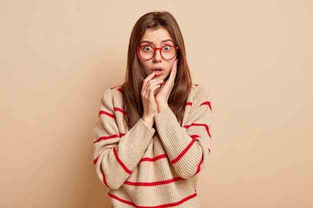 Ginger teenager wearing red eyeglasses