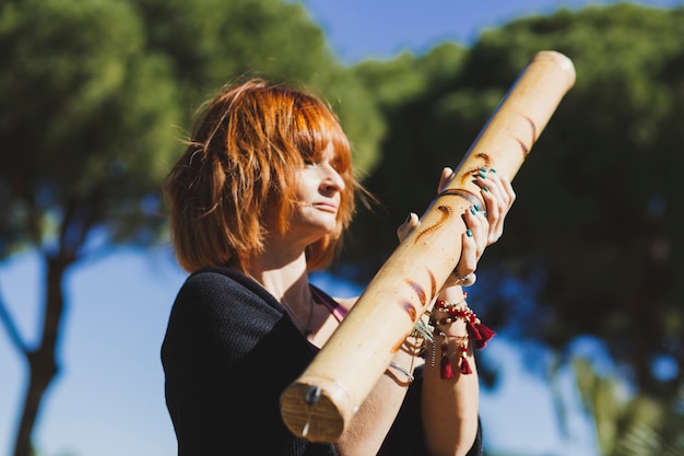 Free Photo ginger woman with bamboo stick