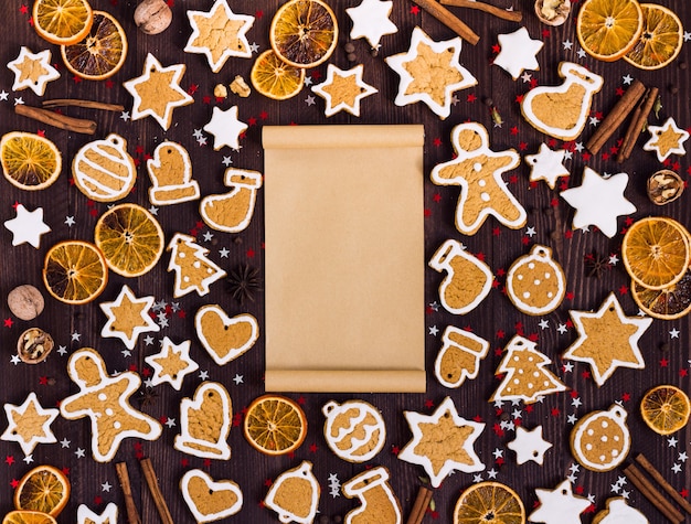 Free photo gingerbread cookies christmas empty paper for recipe new year oranges cinnamon