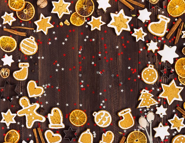 Gingerbread cookies christmas new year oranges cinnamon on wooden table with copyspace