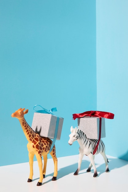 Giraffe and zebra toys carrying presents