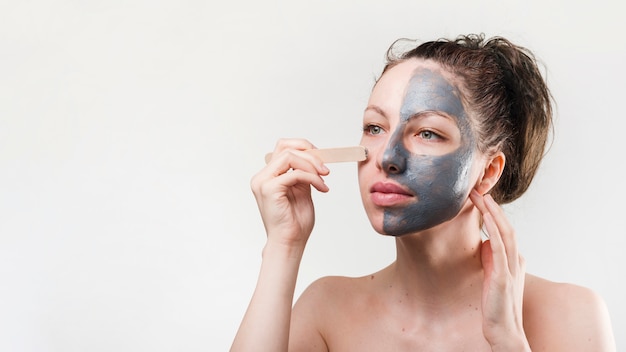 Free Photo girl applying herself cosmetic product