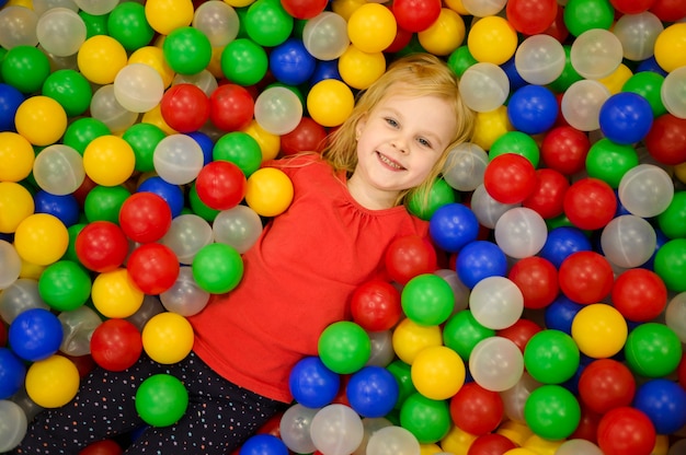 Girl in ball pit top view