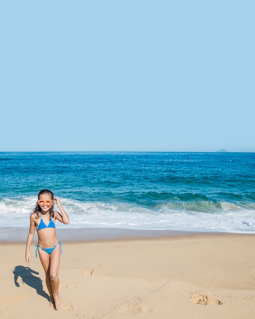 Girl  on the beach with goggles 