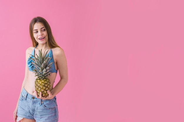 Girl in bikini with pineapple