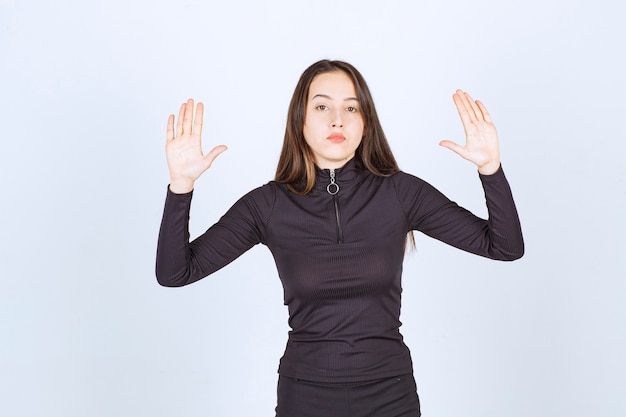 Free photo girl in black clothes trying to stop something.