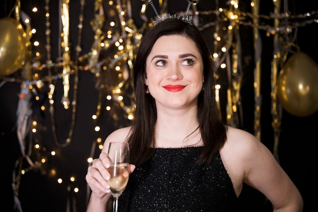 Free photo girl in black dress at new year party