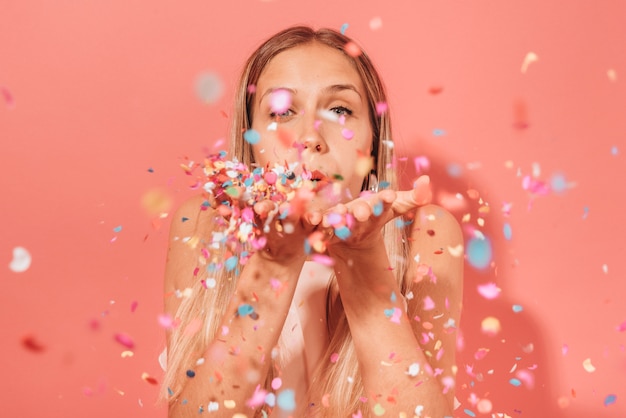 Girl blowing confetti