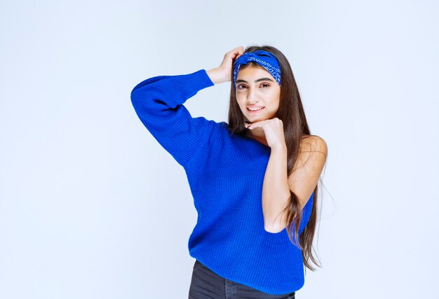 Girl in blue shirt giving seductive and cheerful poses.