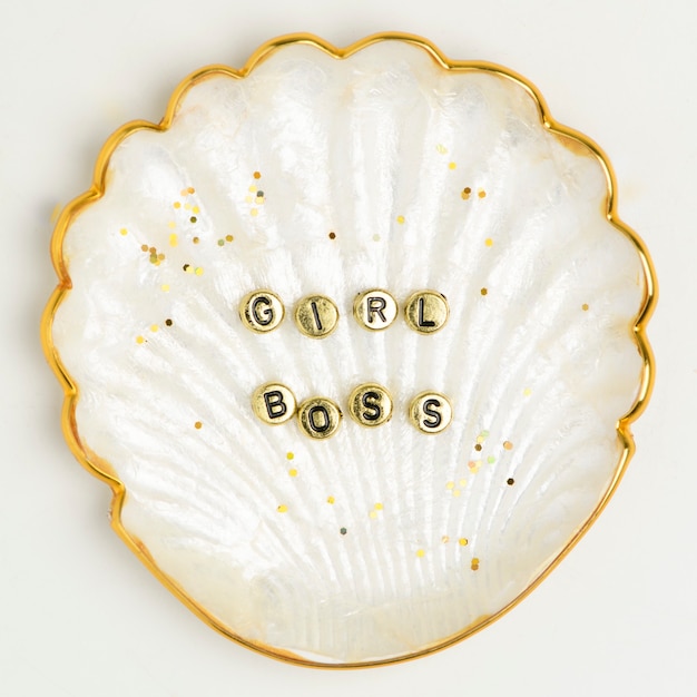 Free photo girl boss beads typography on gold shell