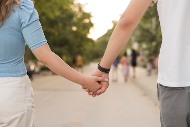 Girl and boy holding hands close-up