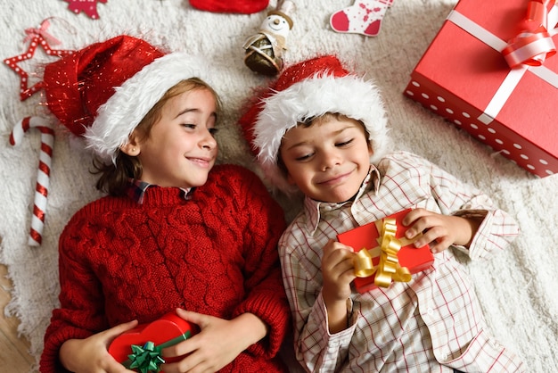 Girl and boy wearing santa hat