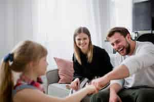 Free photo girl bumping fists with parents