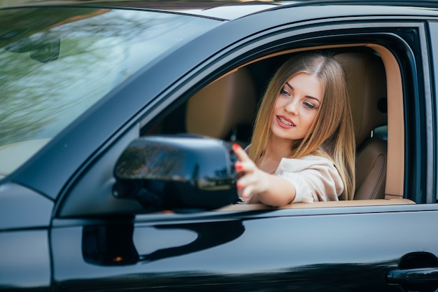 Girl in car arrange mirrow of back view