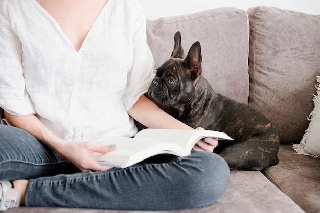 Free photo girl chilling next to her little puppy