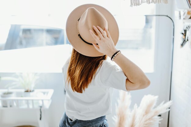 Girl chilling relaxing in hat in bright room