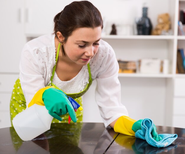 Girl clean table at home