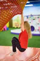 Free photo girl climbing in playground side view