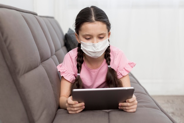 Girl on couch wearing mask