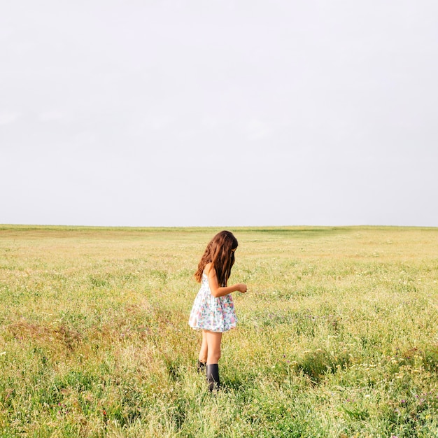 Free Photo girl in cute dress standing in field