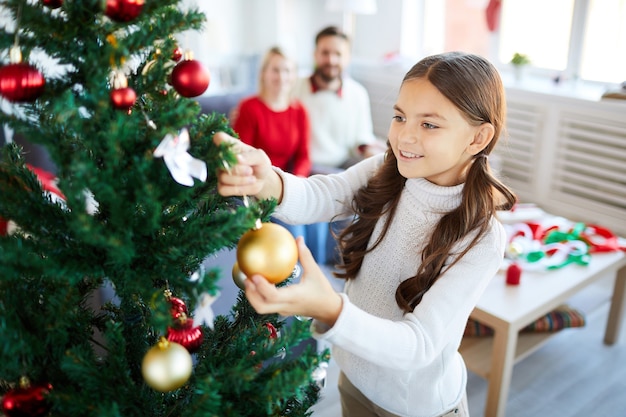 Girl decorating the Christmas tree