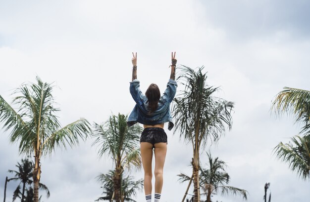 Free photo girl in a denim jacket in a tropical location