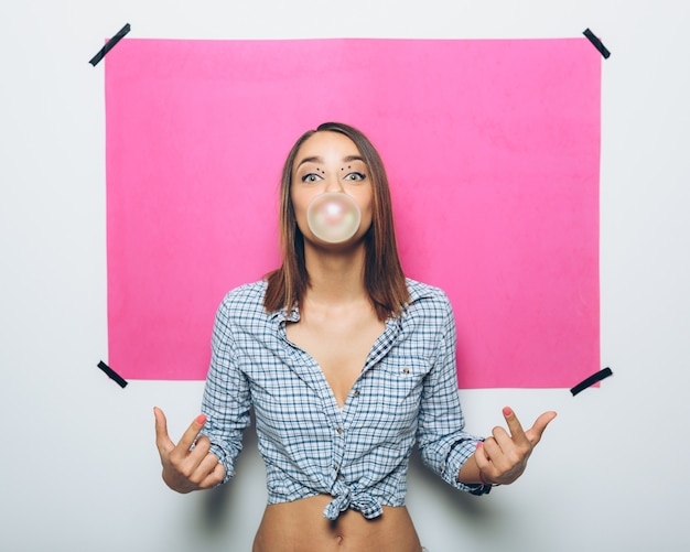 Free Photo girl doing a bubble with a chewing gum