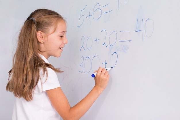 Girl doing math on a whiteboard