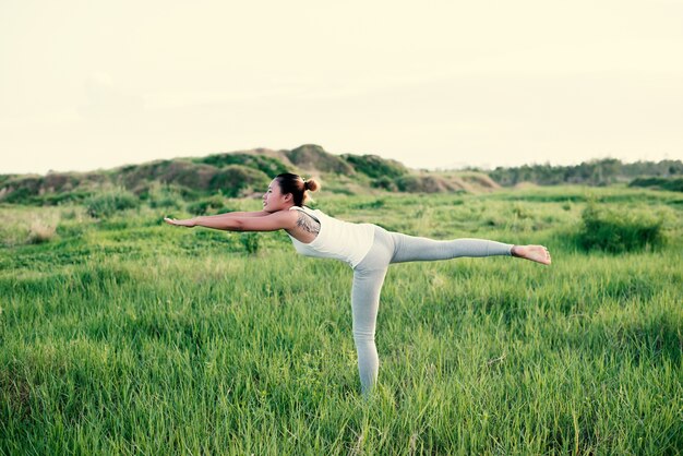 Girl doing yoga on one leg