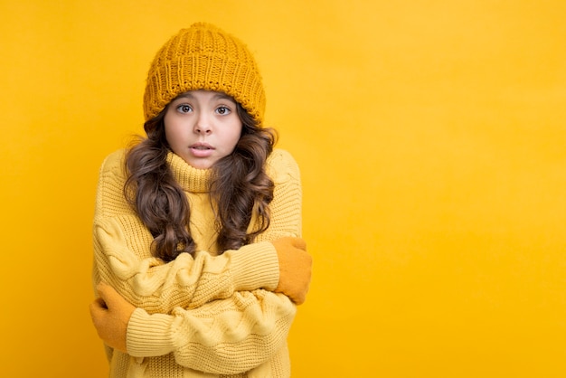 Girl dressed in yellow with crossed hands