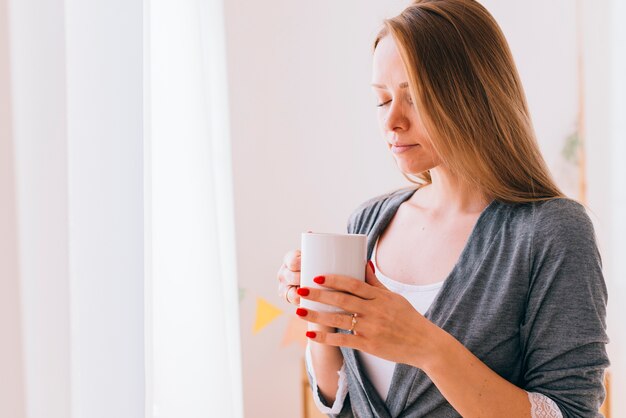 Free Photo girl drinking coffee in the morning