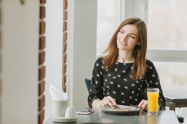 Girl eating in a restaurant