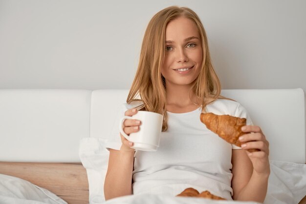 Girl enjoying breakfast in bed