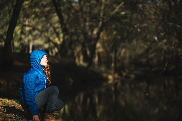 Girl enjoying weather near pond