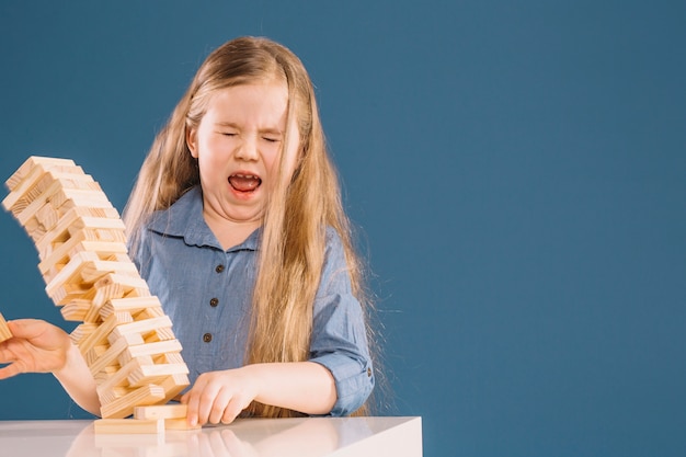 Girl and falling jenga tower