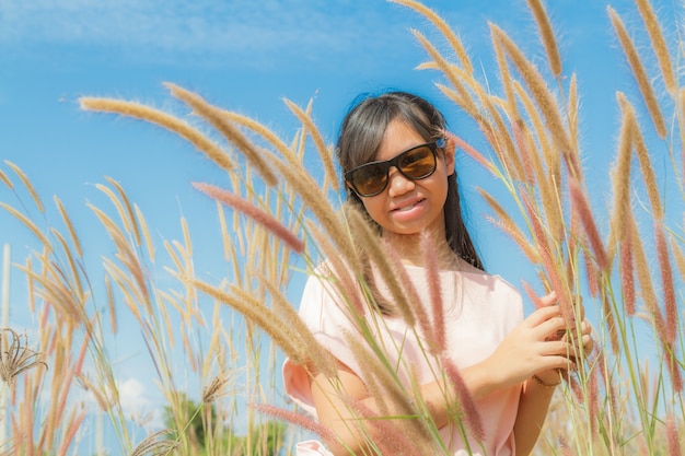 Free photo girl and feather pennisetum