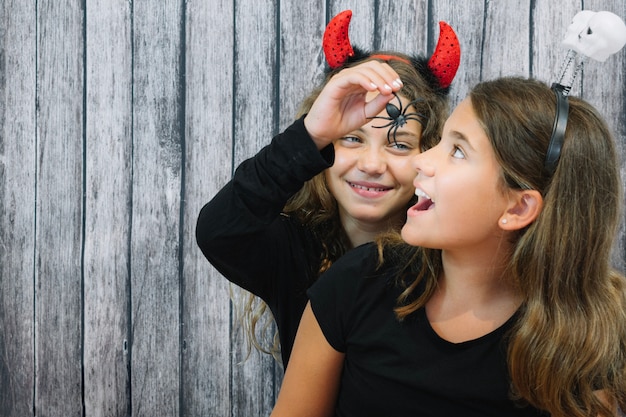 Free Photo girl feeding spider to her friend