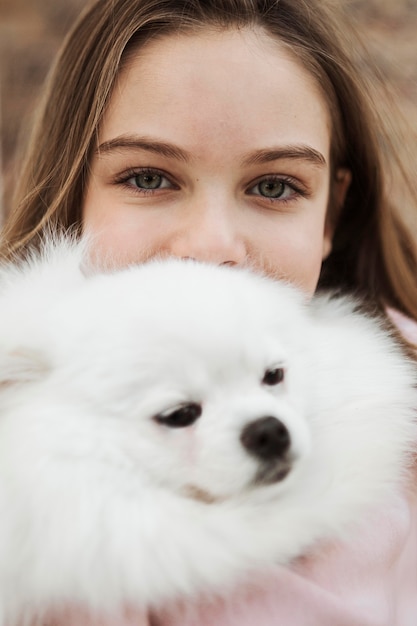 Free photo girl and fluffy dog close-up