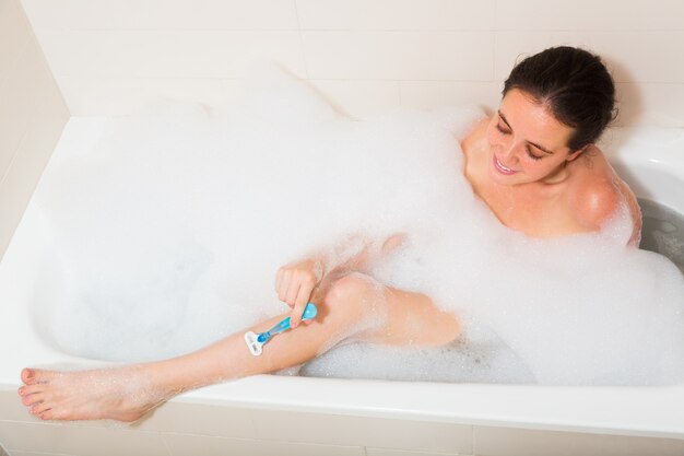 Girl in foam at bathtub