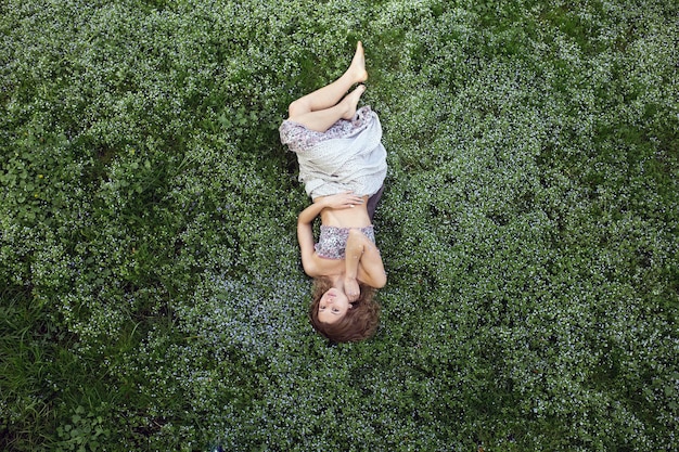 Free photo girl in garden shooted from above