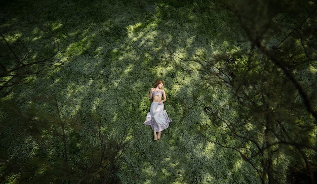 Free photo girl in garden shooted from above