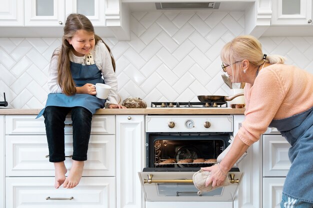 Girl and grandma cooking medium shot