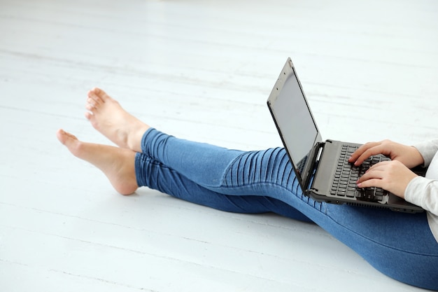 Girl on the ground with a laptop