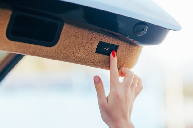 Free Photo girl hand open baggage section in car