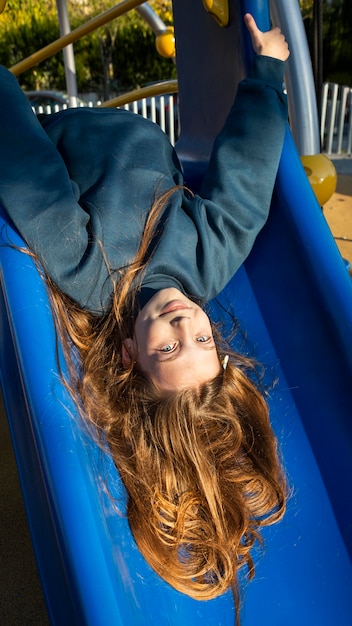 Free photo girl having fun on a slide outdoors