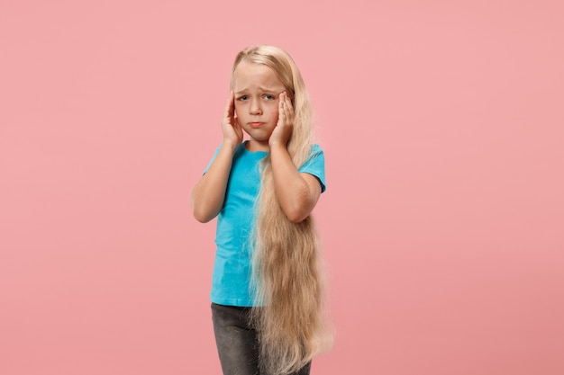 Free photo girl having headache. isolated over pink