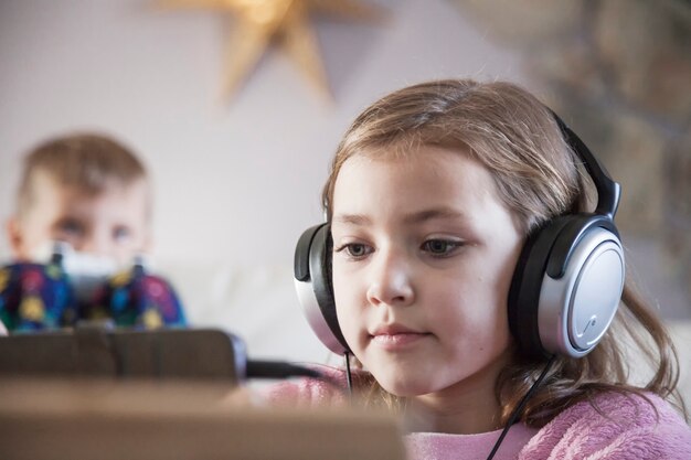 Girl in headphones browsing tablet