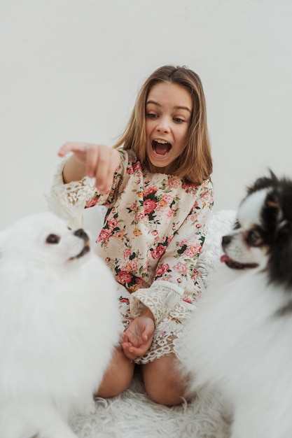 Free photo girl and her dogs receiving treats