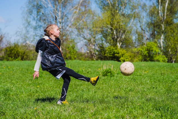 Free photo girl hitting a soccer ball